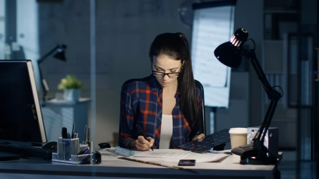 a female engineer working on a solar cell in her lab