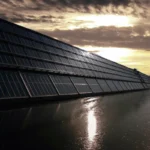 solar panels on the side of a building next to a waterway